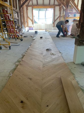 white oak chevron floor installation in Watermill