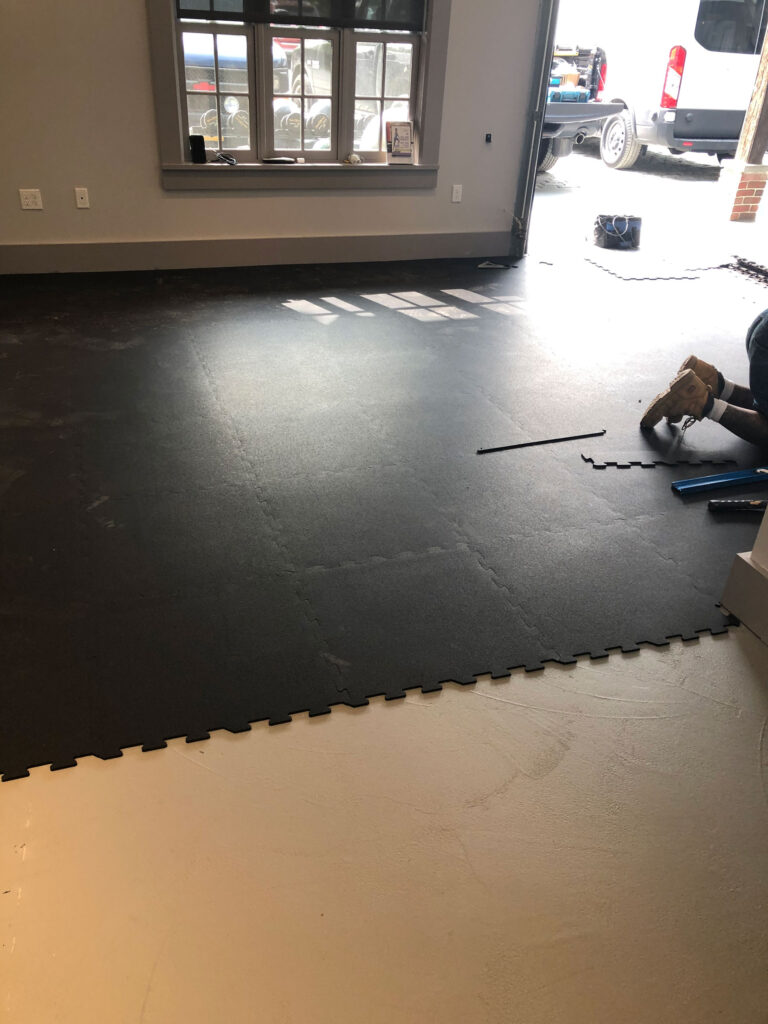 Rubber gym floor installation with interlocking tiles