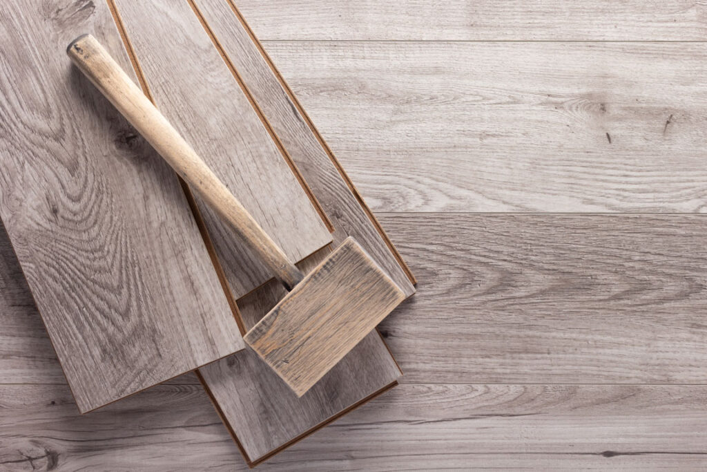 wooden hammer over hardwood flooring