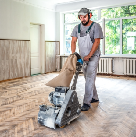 man sanding floor