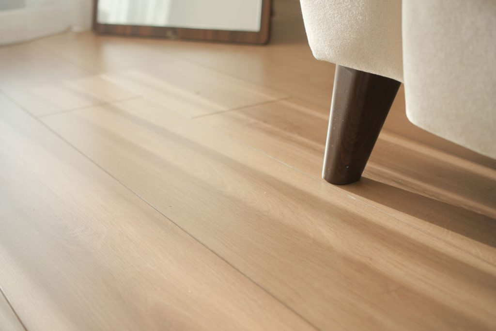 wood-floor-and-furniture-leg-with-reflected-light vinyl flooring under chair